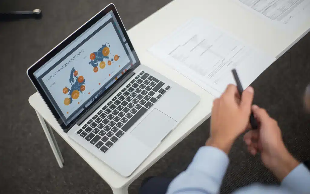 Local SEO guide showing a professional reviewing SEO analytics and business growth charts on a laptop in a modern office setting