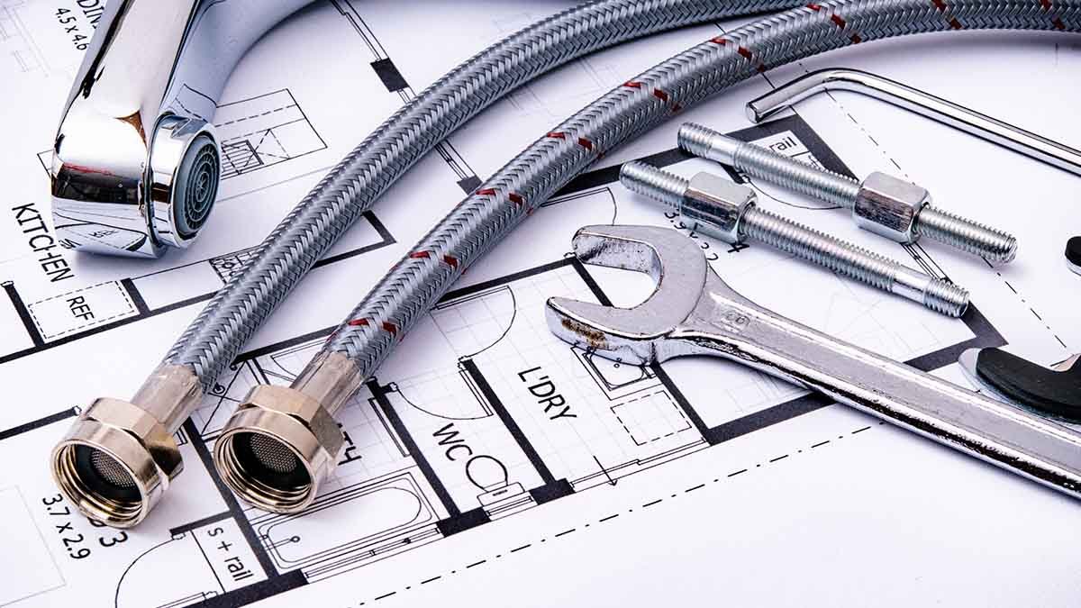 Local SEO for Dallas plumbers with plumbing tools and faucet on architectural blueprint