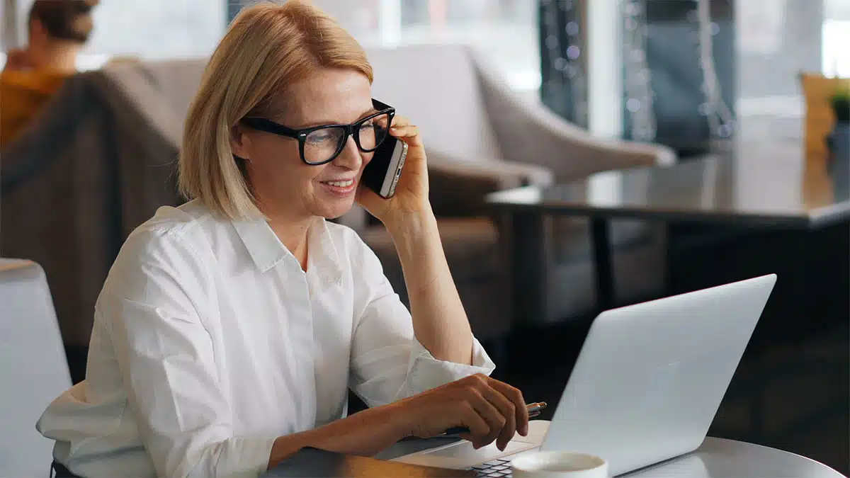 Business owner managing customer calls and marketing automation from a laptop